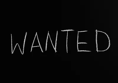 "Wanted" written in chalk on a blackboard