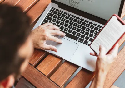 Man working on laptop and mobile at the same time