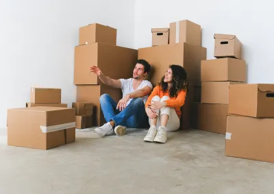 Couple in front of boxes, imagining the future