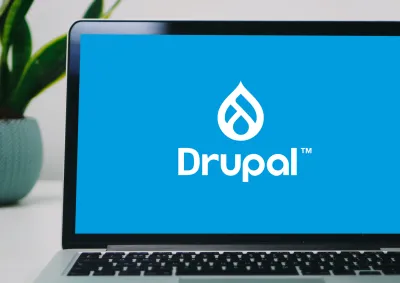 A laptop with Drupal logo