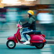 A scooter speeding through the street