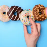 Person picking a donut